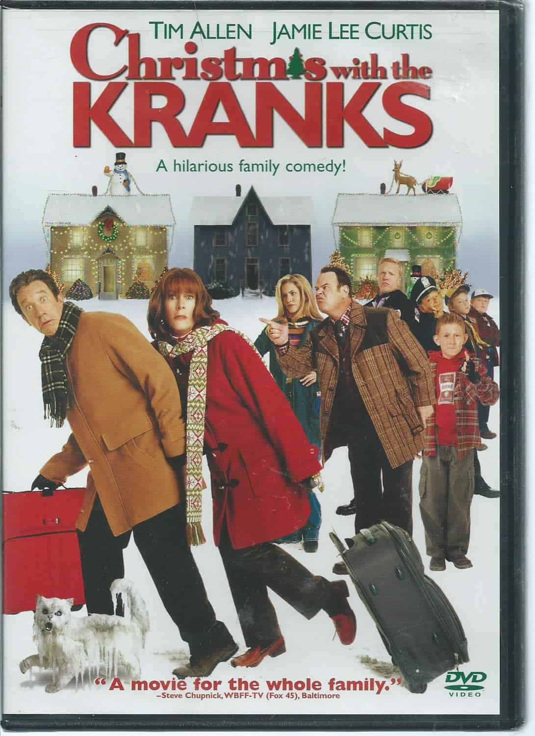 DVD cover for "Christmas with the Kranks" showing the main cast in winter clothes with suitcases, snowy houses in the background, and a white cat in the foreground.