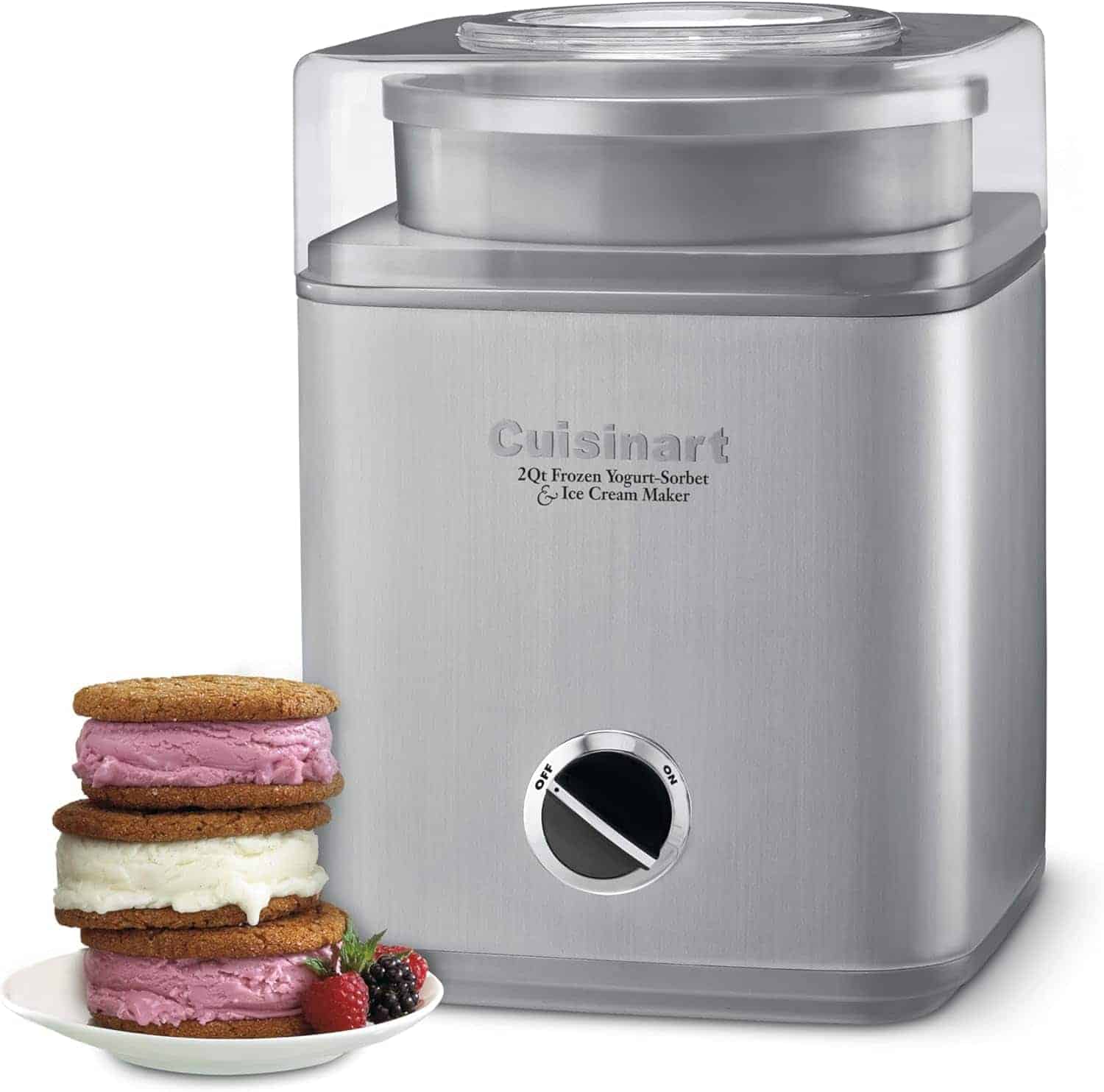 A stainless steel Cuisinart ice cream maker with a control dial is shown next to three ice cream cookie sandwiches and assorted berries.