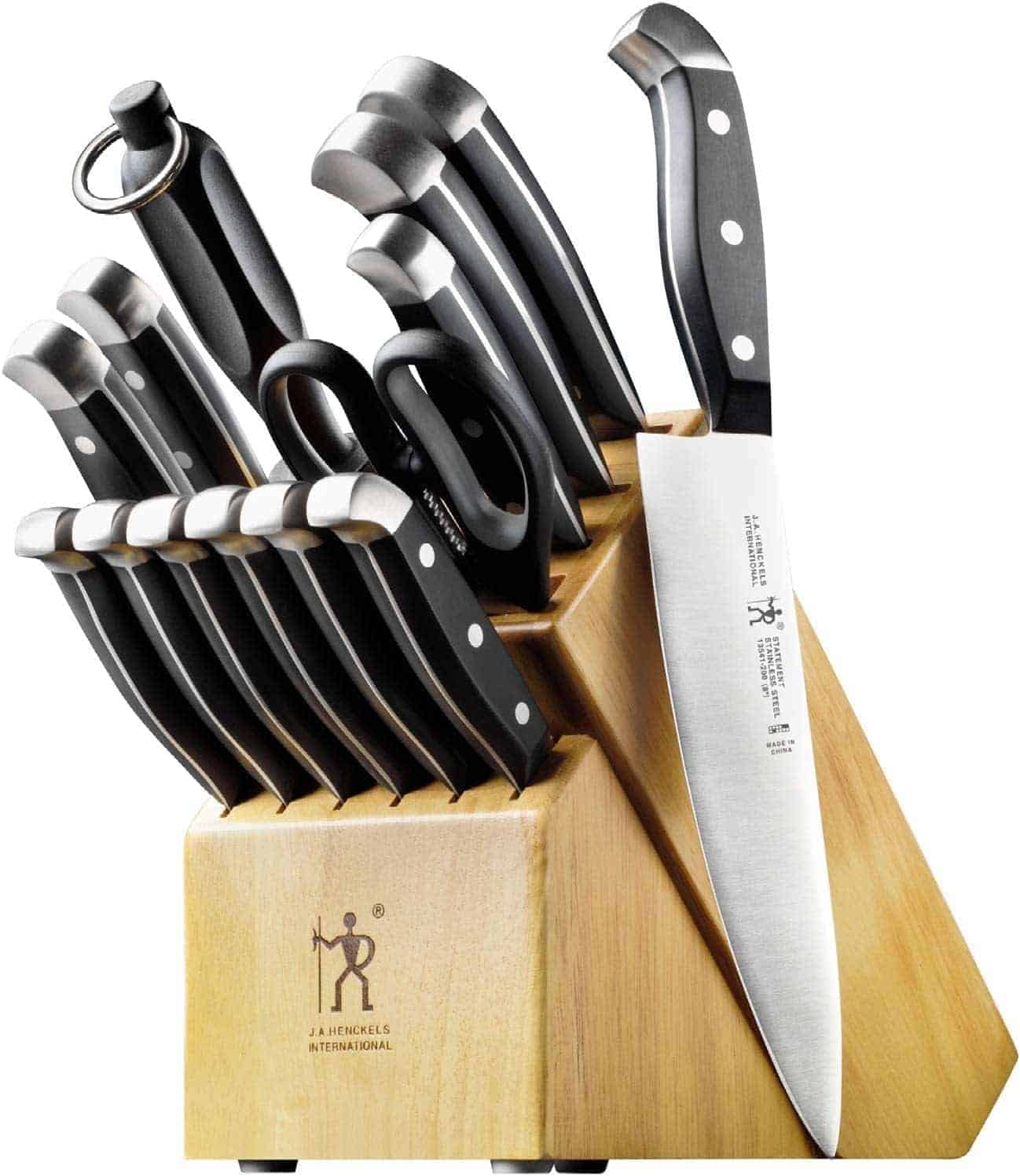 A wooden knife block holds various kitchen knives, scissors, and a sharpening rod, all with black handles and silver rivets.