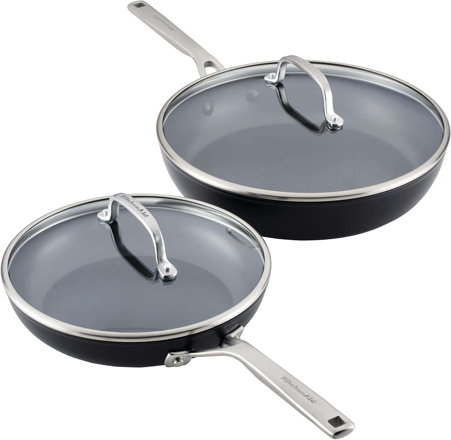 Two nonstick frying pans with glass lids and metal handles, one smaller and one larger, placed side by side on a white background.