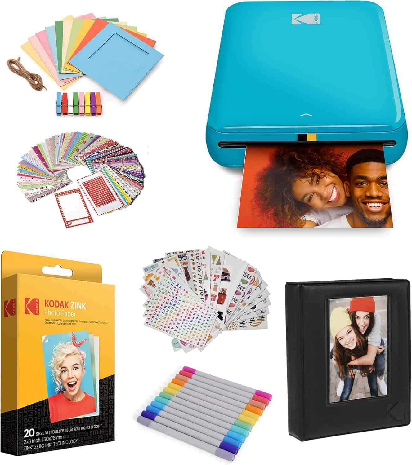 A collection of photo printing and crafting supplies, including a blue Kodak printer, photo paper, stickers, colored pens, blank cards, string, and a small photo album.