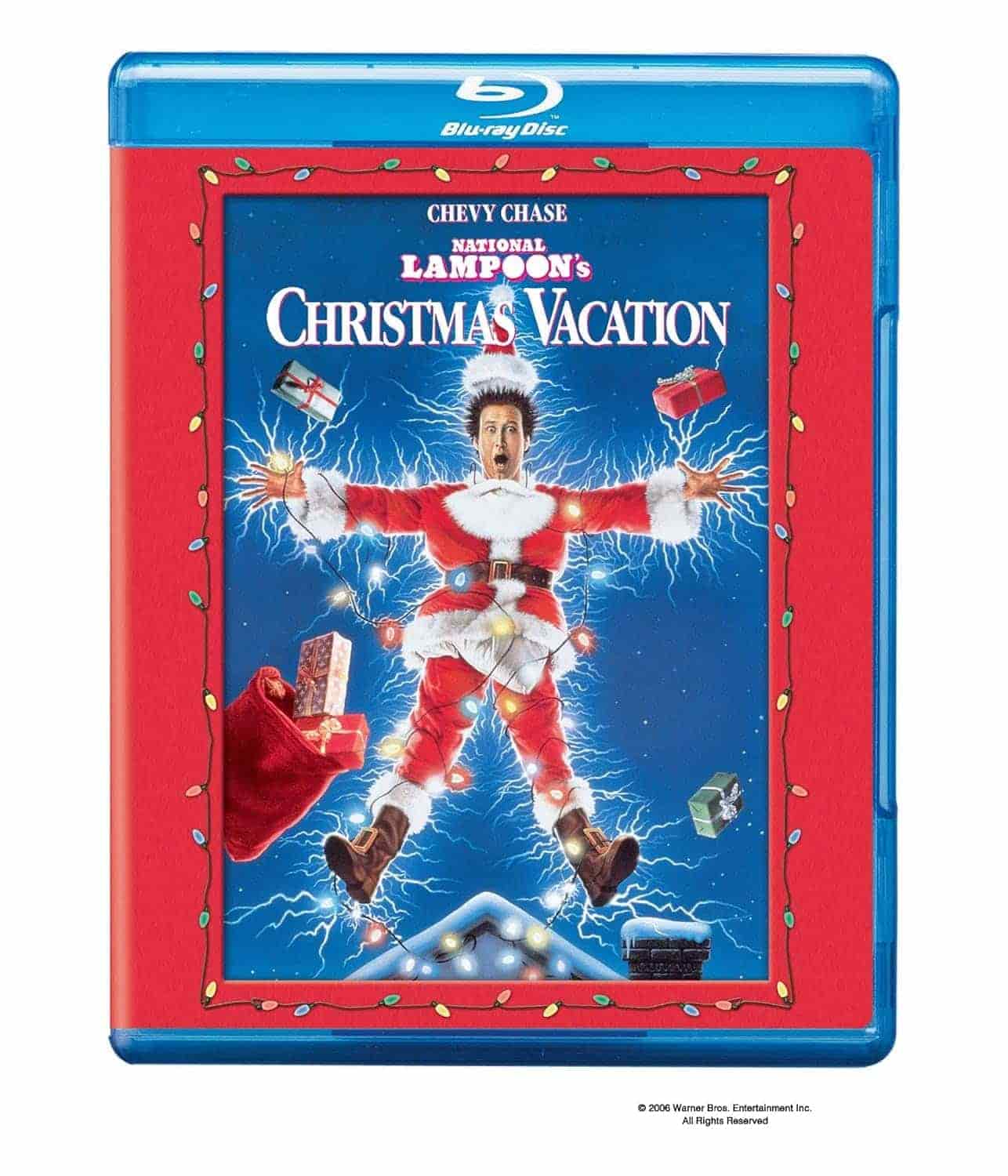 Blu-ray cover of "National Lampoon's Christmas Vacation" showing a man in a Santa suit being electrocuted, surrounded by gifts and holiday lights, with a blue and red border.