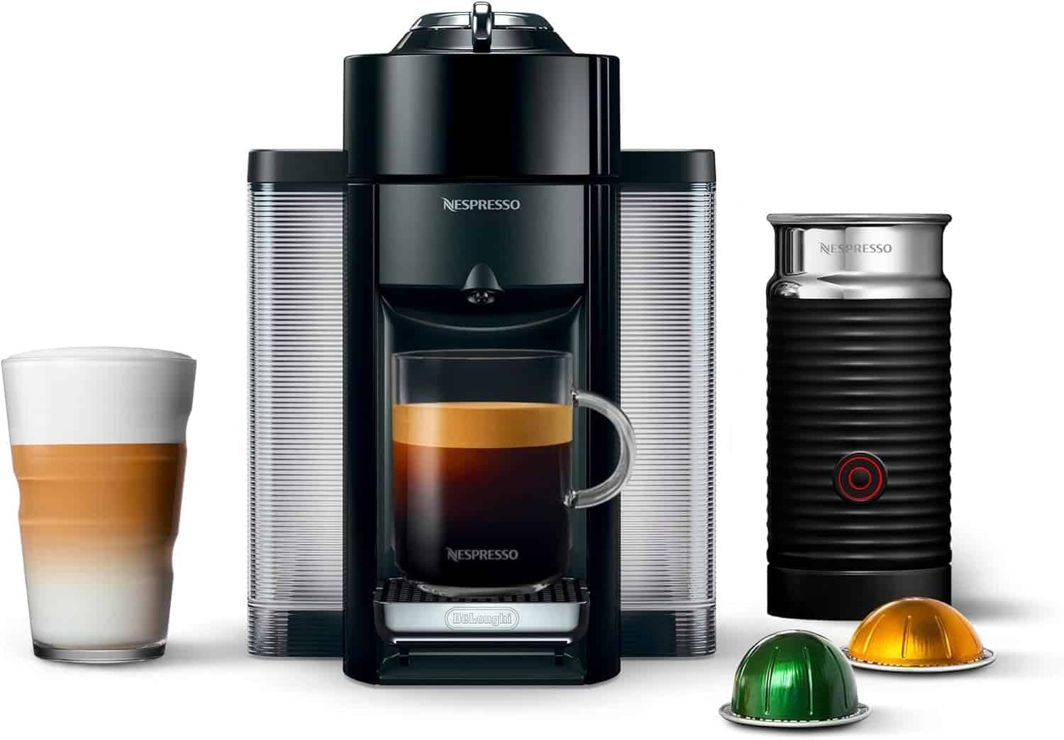A Nespresso coffee machine with a glass mug, milk frother, two coffee pods, and a latte in a tall glass, all placed side by side.