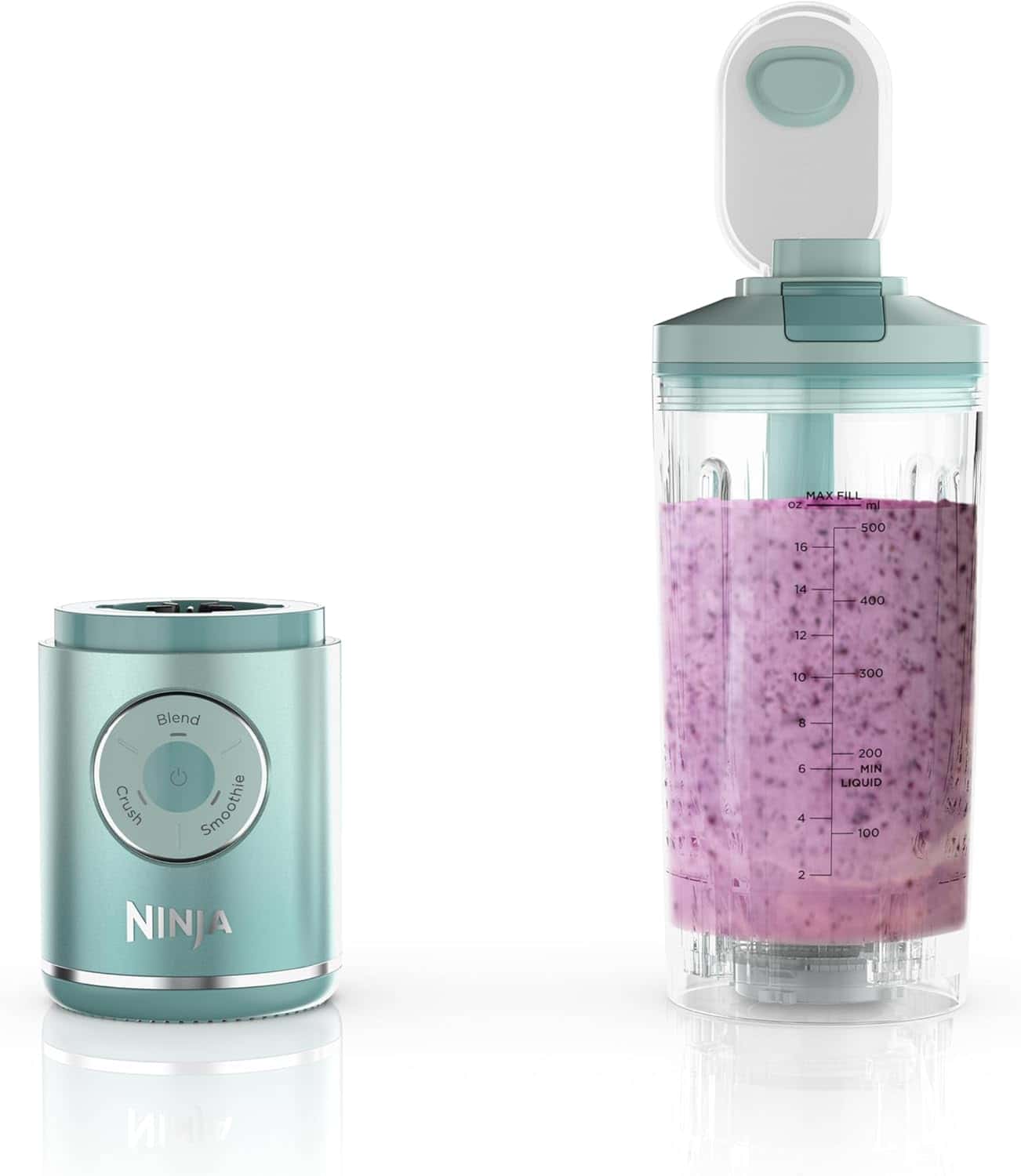 A Ninja blender with a detachable blending cup filled with a purple smoothie, showing measurement markings, is placed beside the blender base.