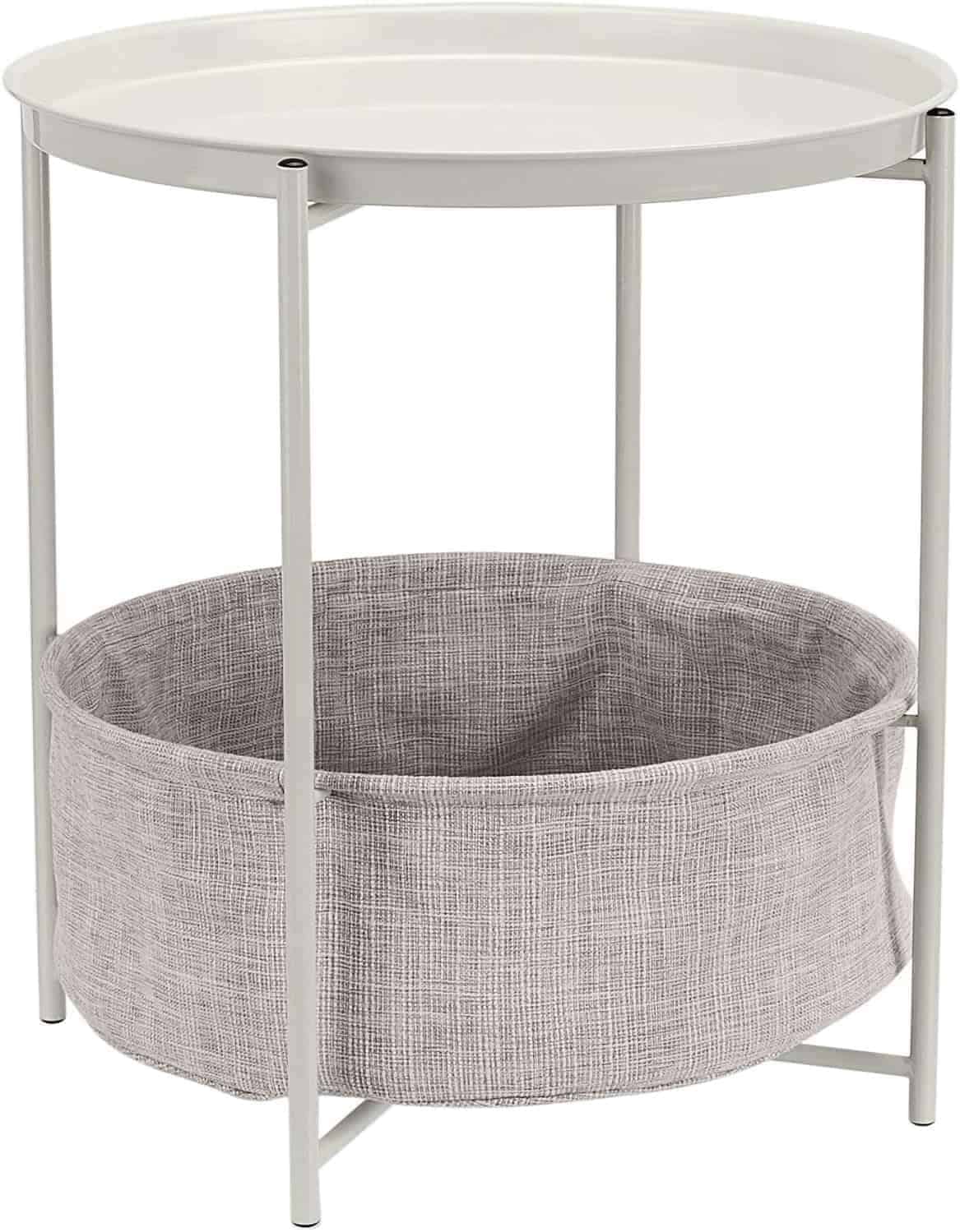 A small round side table with a white tray top and metal frame, featuring a gray fabric storage basket attached below.