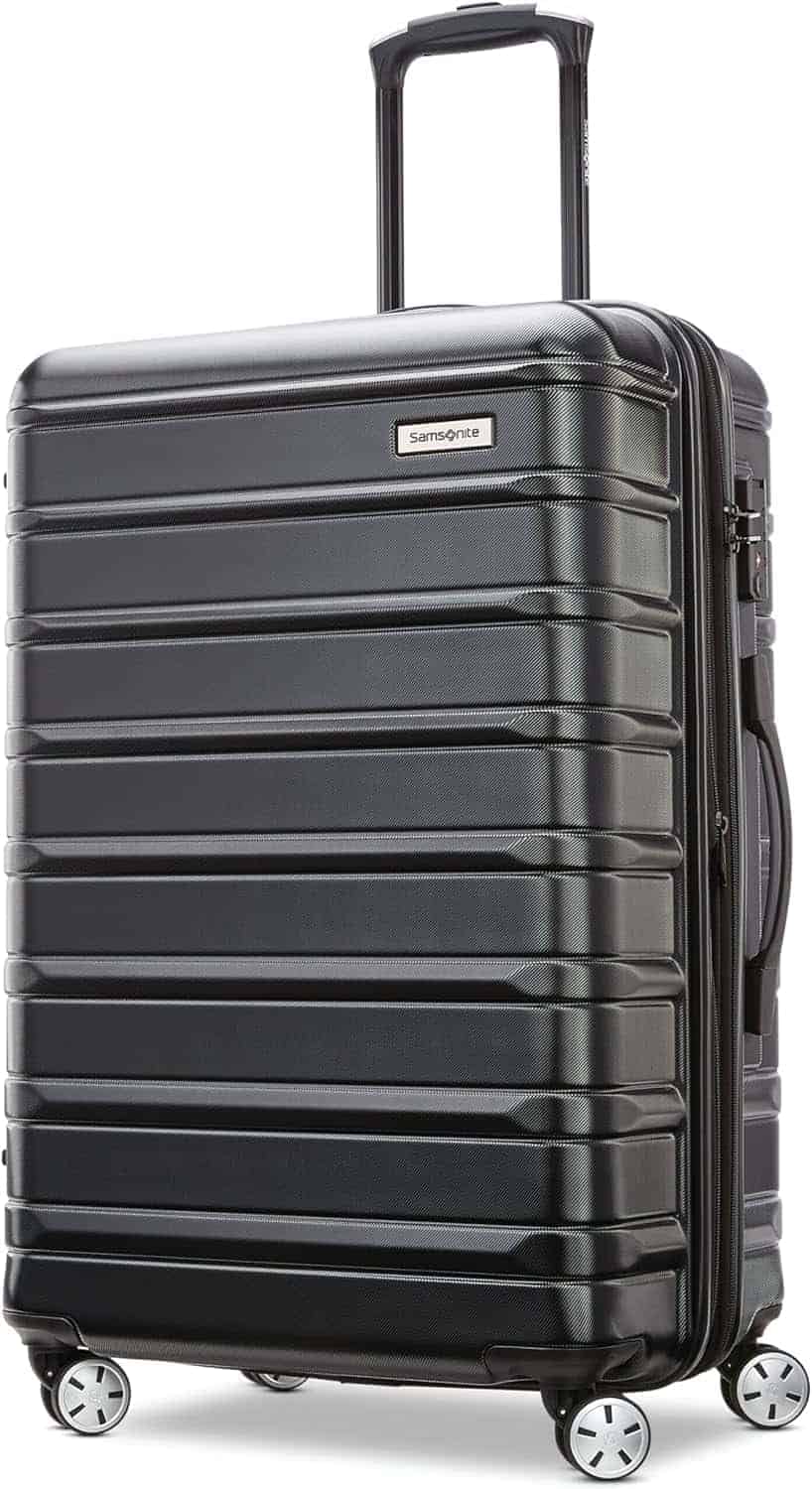 Black hard-shell Samsonite suitcase with four spinner wheels, a retractable handle, and horizontal ridges, standing upright on a white background.