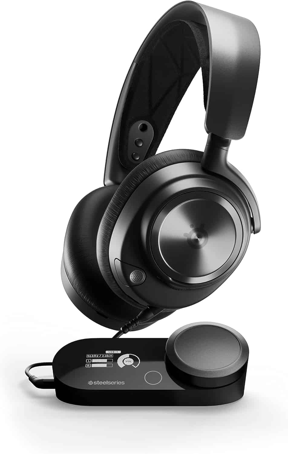 A black SteelSeries gaming headset rests on a wireless transmitter base with a control dial and display screen.