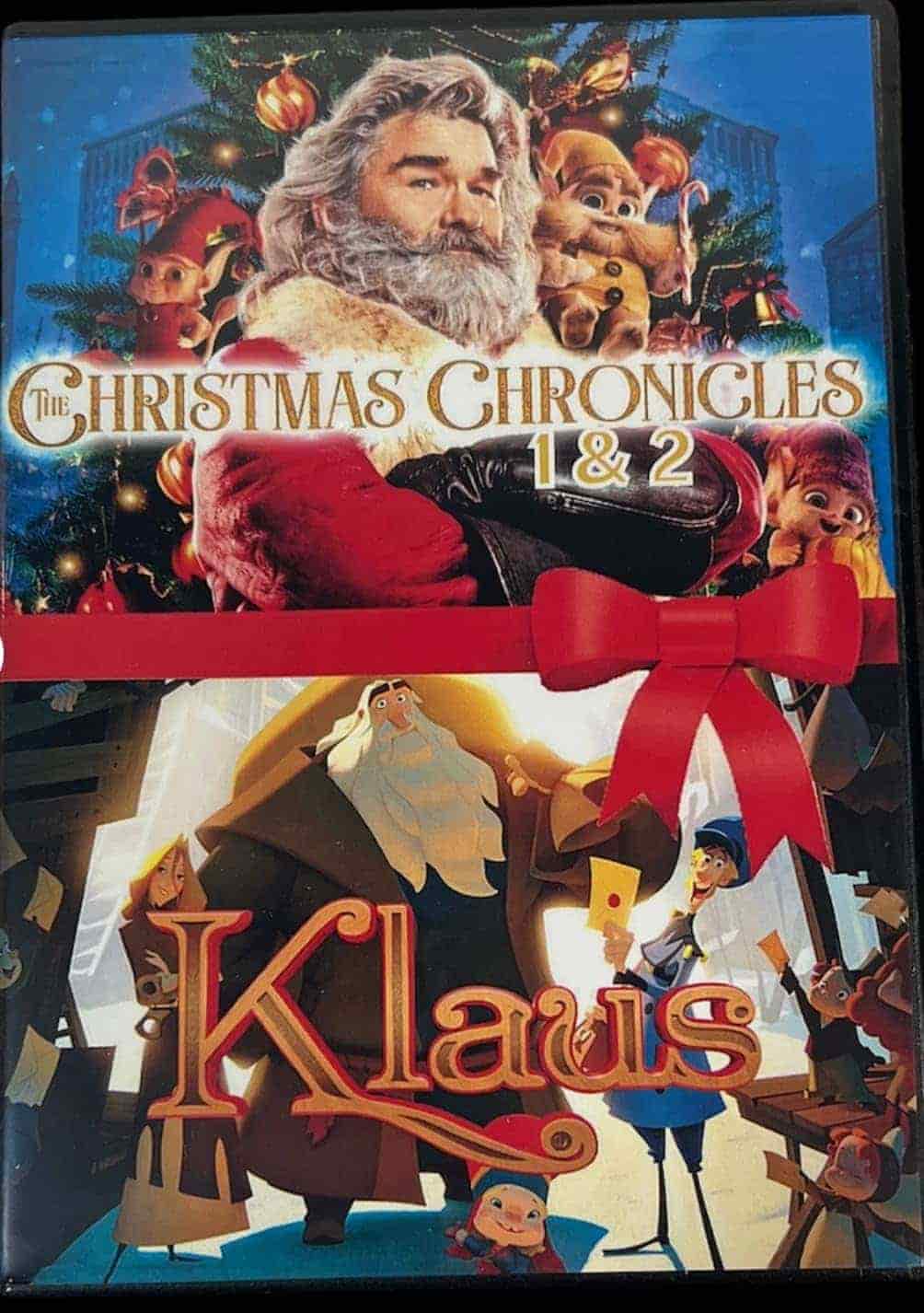 DVD cover shows two Christmas movies: "The Christmas Chronicles 1 & 2" featuring Santa with elves, and "Klaus," an animated film with Santa and children, both with festive backgrounds.