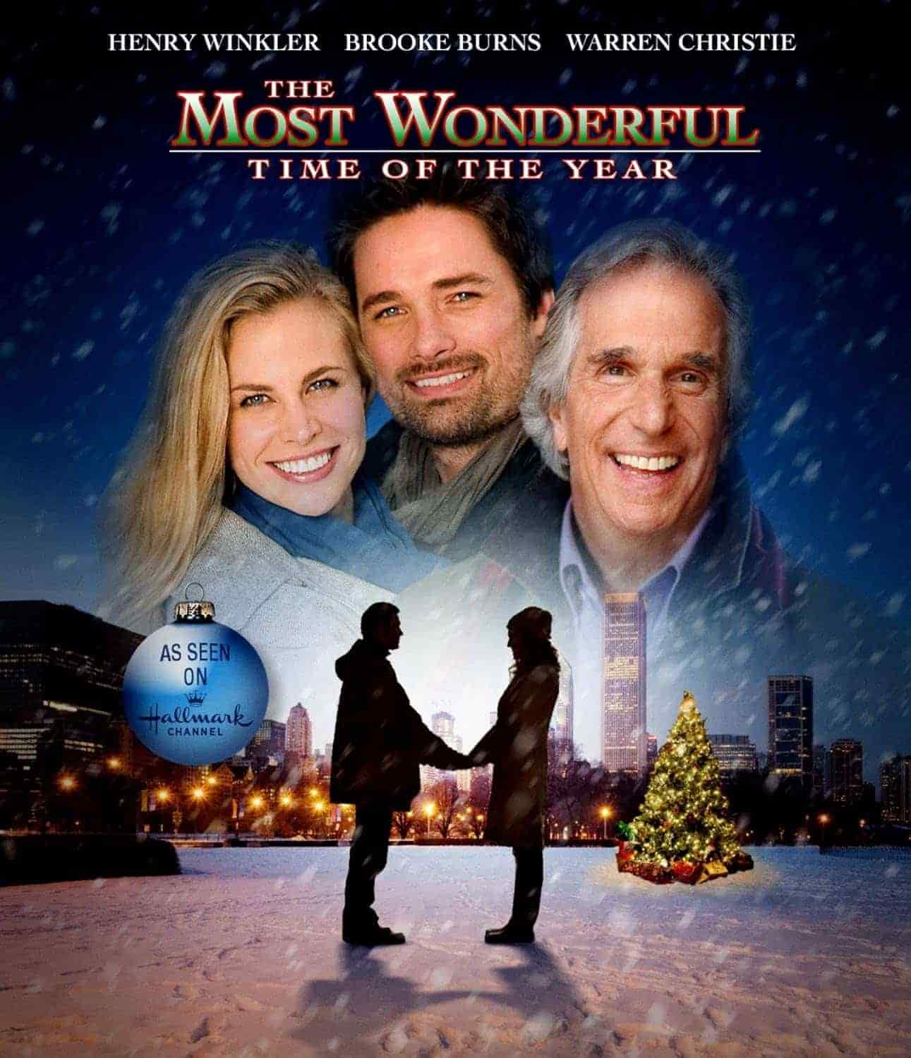 Movie poster for "The Most Wonderful Time of the Year" featuring three smiling adults above a couple holding hands in front of a Christmas tree in a snowy city park, with holiday decorations.