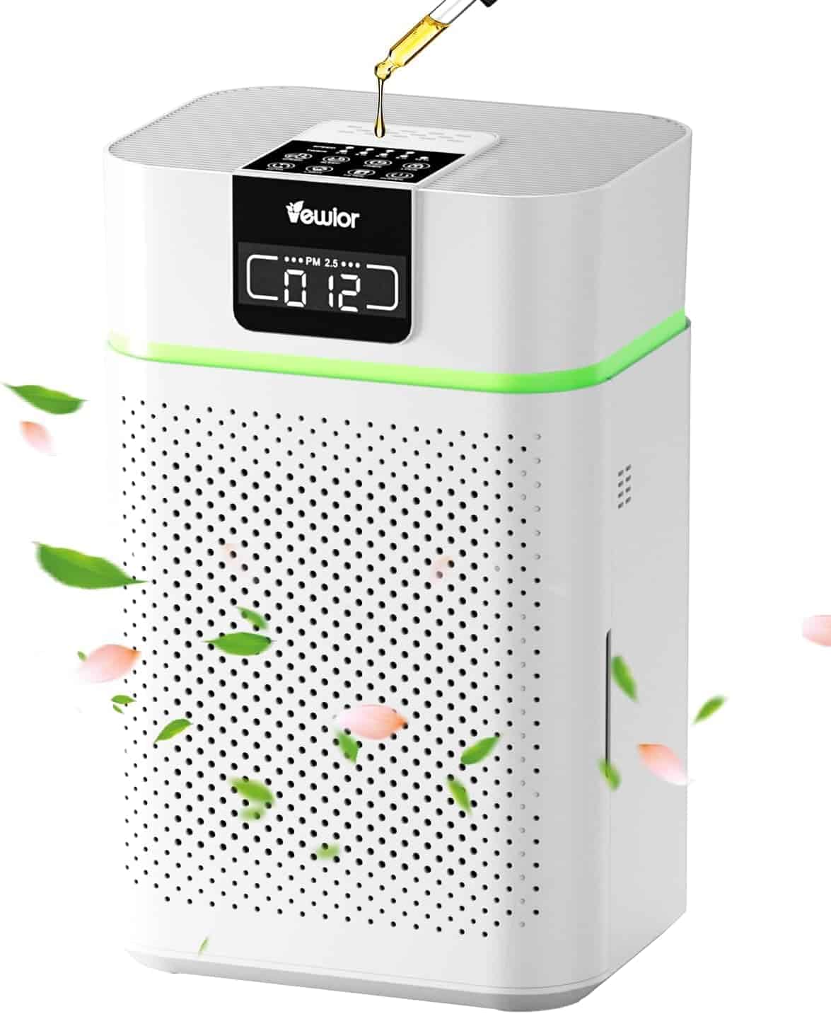 White air purifier with digital display, green light band, and oil being dripped into the top, surrounded by floating green leaves and pink petals.
