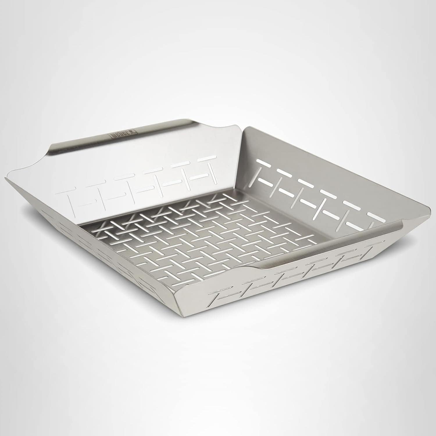 A stainless steel grill basket with slotted sides and bottom, designed for grilling vegetables or small foods.