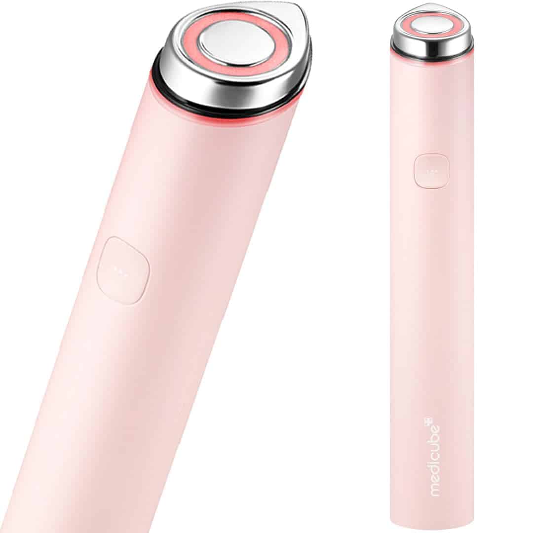 A pink handheld skincare device with a round metal head and a button on its side, labeled "medicube*" near the bottom.
