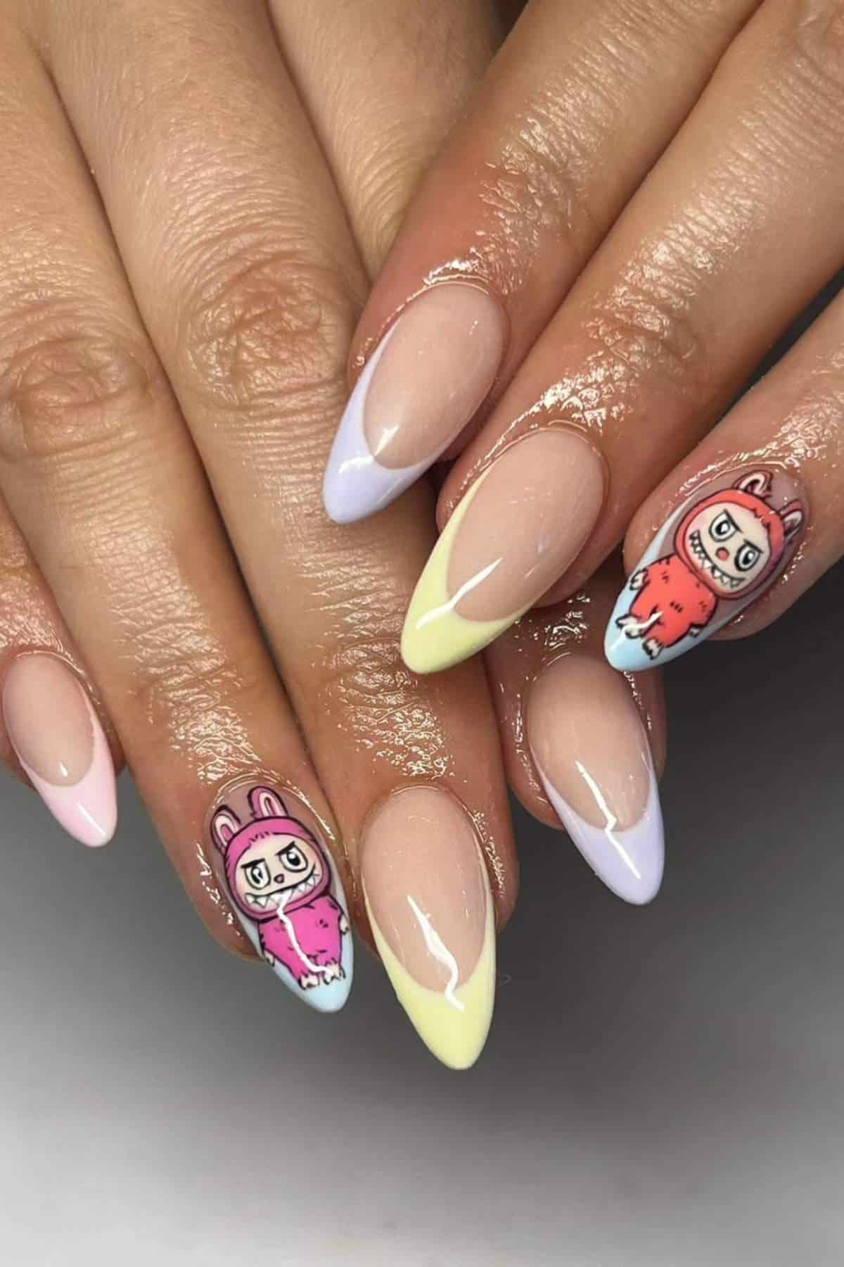 Hands with almond-shaped nails featuring pastel French tips and cartoon animal characters painted on the ring fingers.