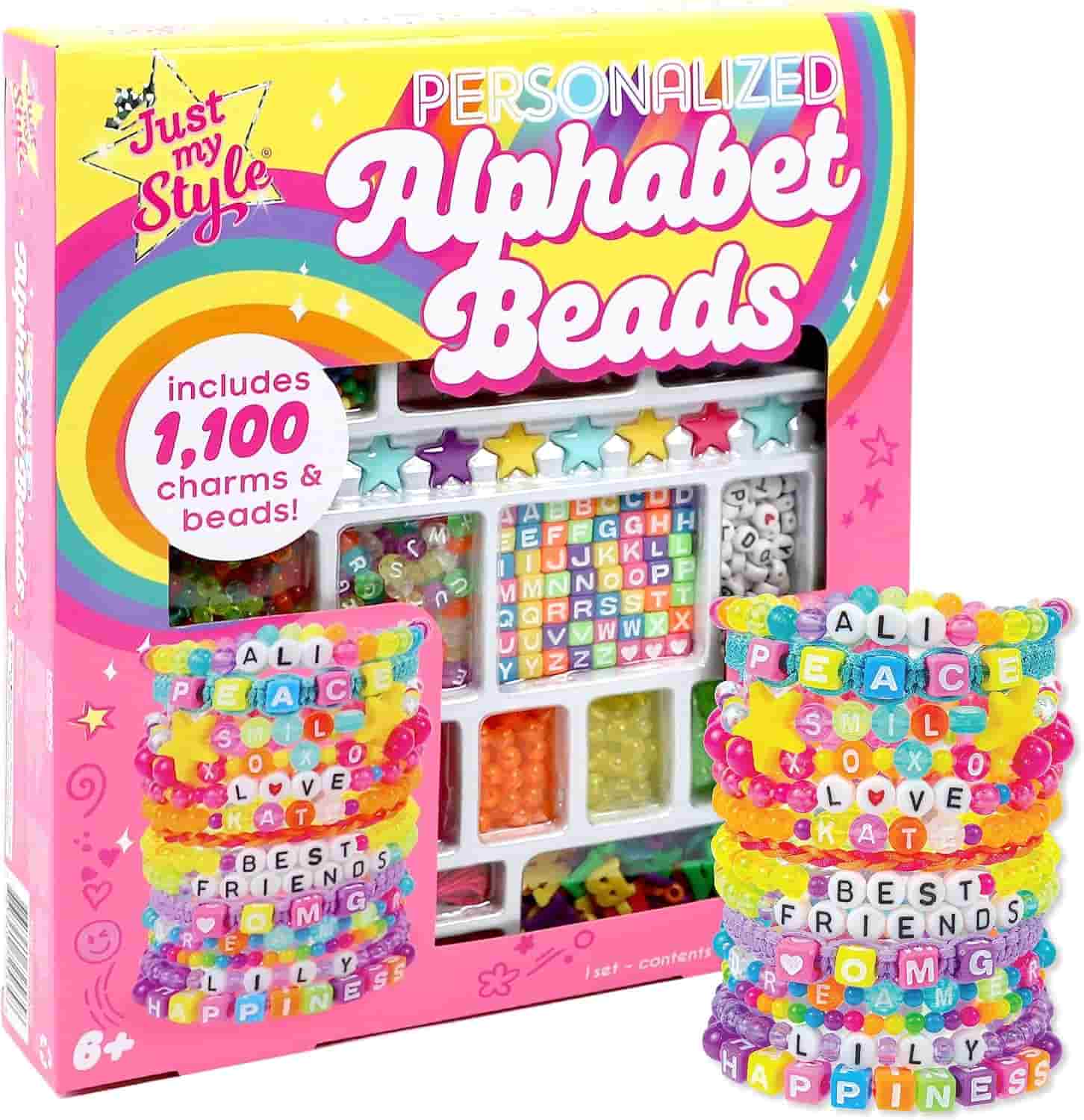 A colorful craft kit box labeled "Personalized Alphabet Beads" with 1,100 beads, charms, and example bracelets shown on the front.