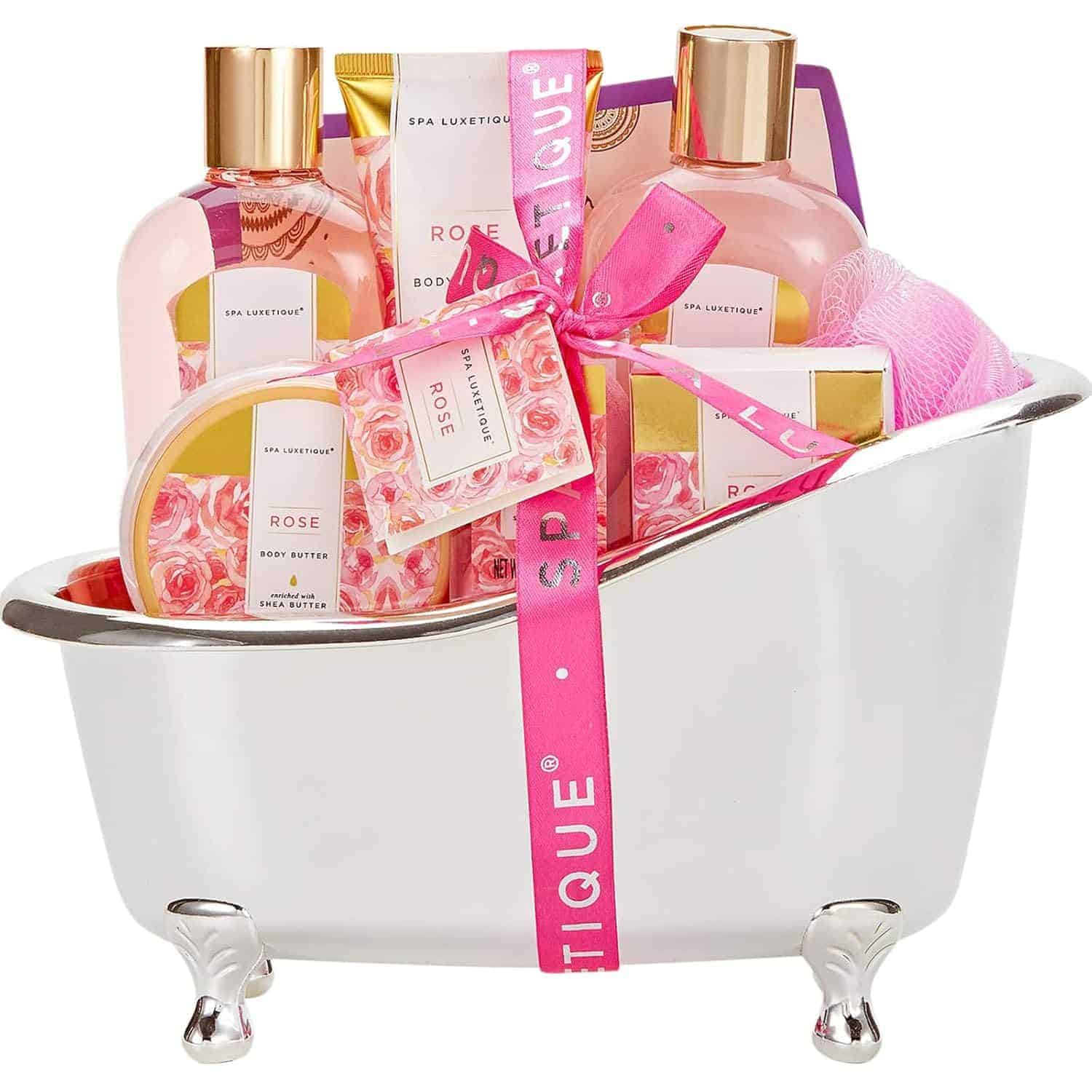 Gift set in a silver bathtub container with rose-themed bath products, including shower gel, body lotion, body butter, bar soap, and a pink bath pouf.