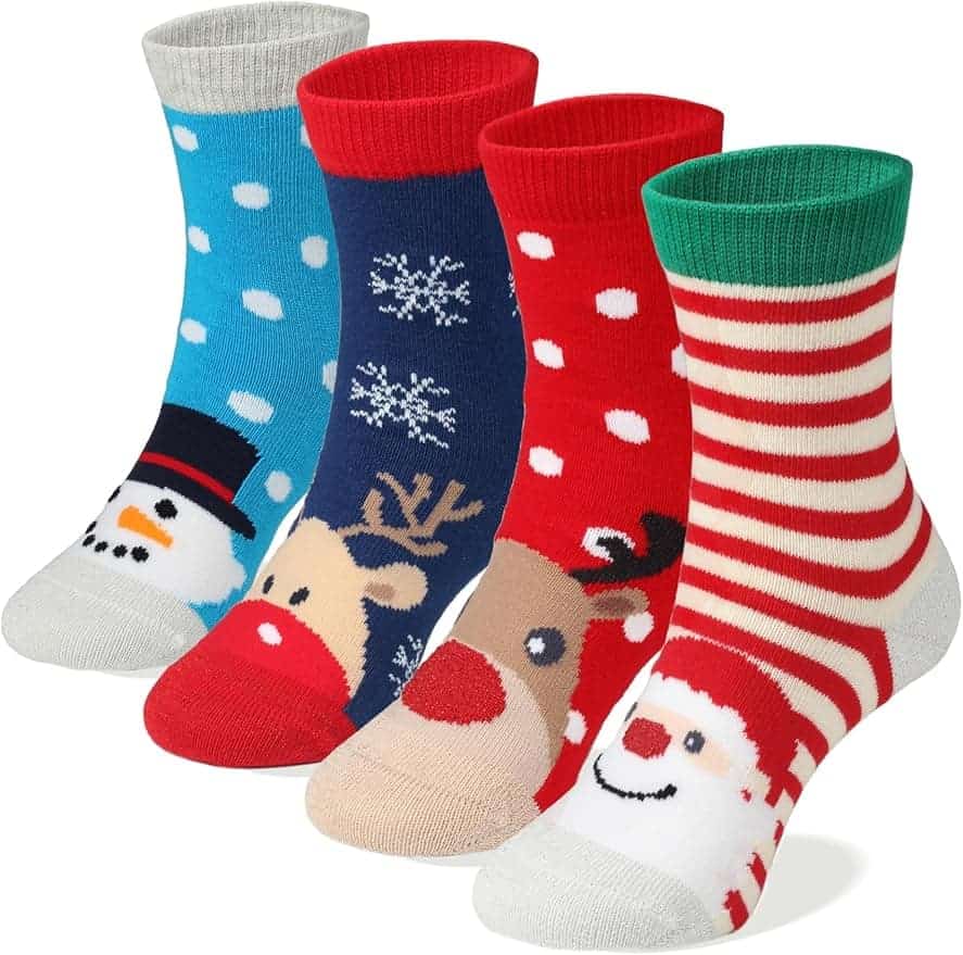 Four pairs of festive socks featuring designs of a snowman, reindeer, polka dots with snowflakes, and Santa Claus with red and white stripes.