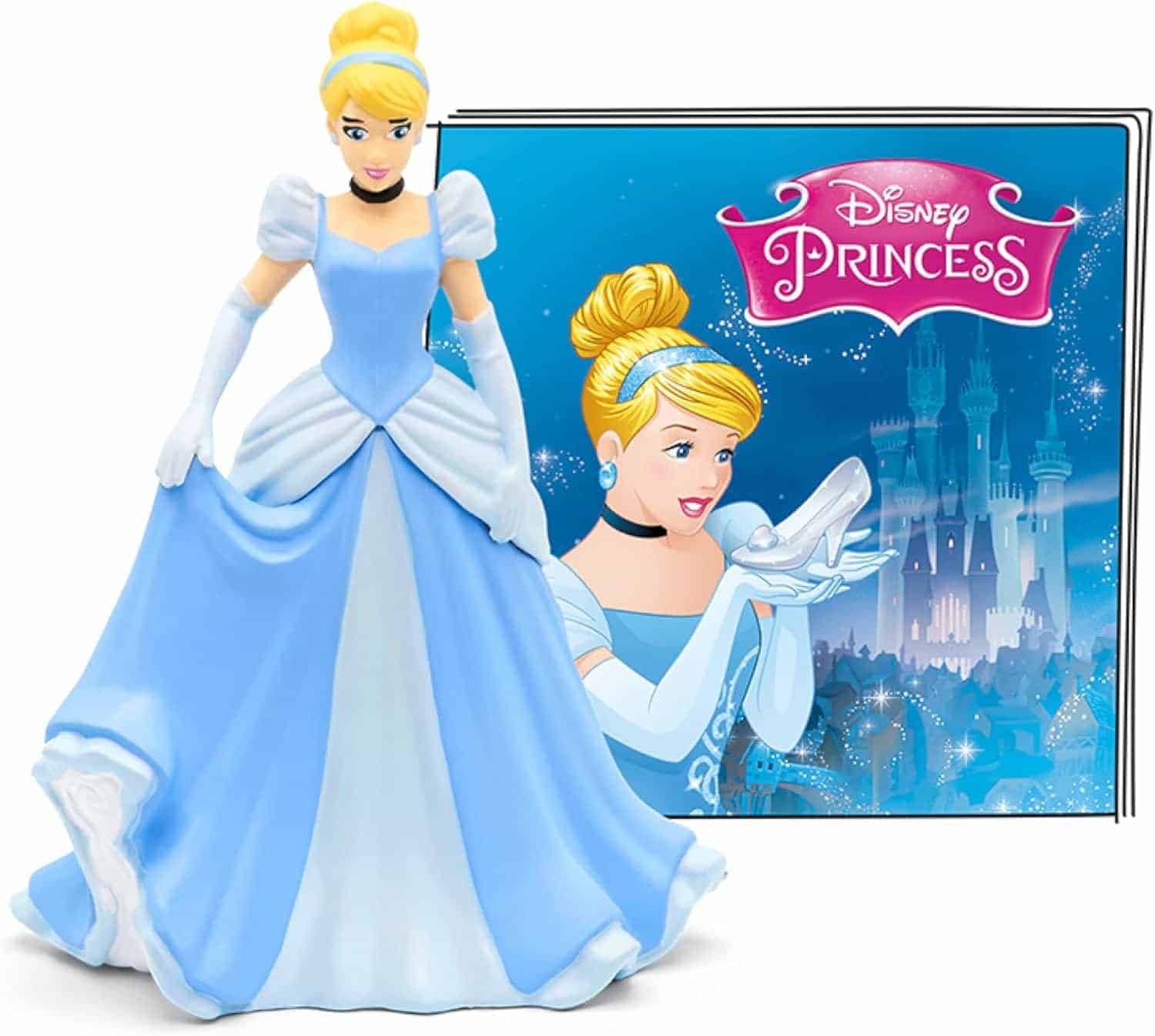 A figurine of Cinderella in a blue dress stands in front of a Disney Princess book featuring an illustration of Cinderella holding a glass slipper.