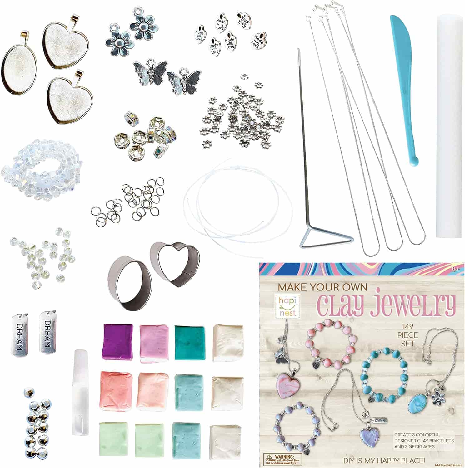 Flat lay of a 149-piece clay jewelry kit showing colorful clay blocks, metal findings, charms, tools, and an instruction booklet for making jewelry pieces.