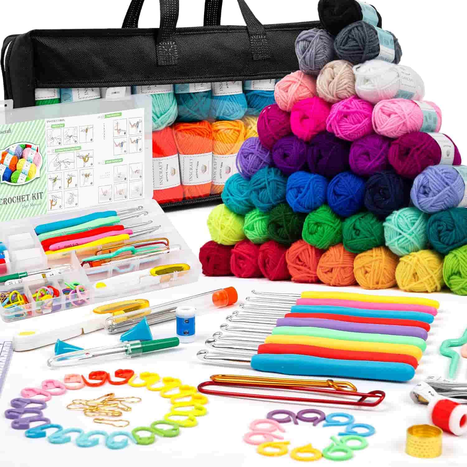 A crochet kit with colorful yarn balls, crochet hooks, stitch markers, and various tools, displayed neatly in front of a black carrying case.