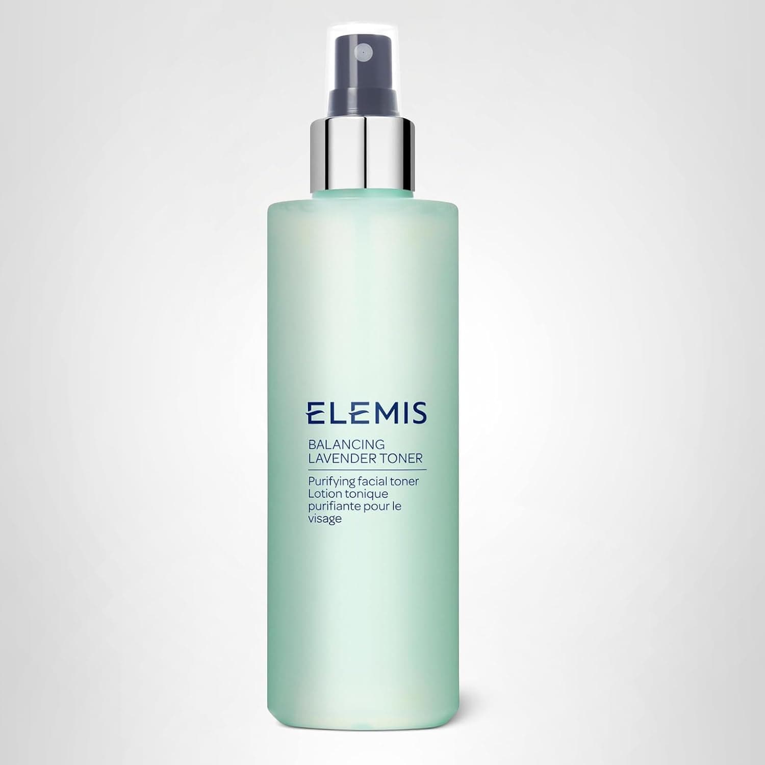A translucent green bottle of Elemis Balancing Lavender Toner with a spray nozzle and text describing it as a purifying facial toner.