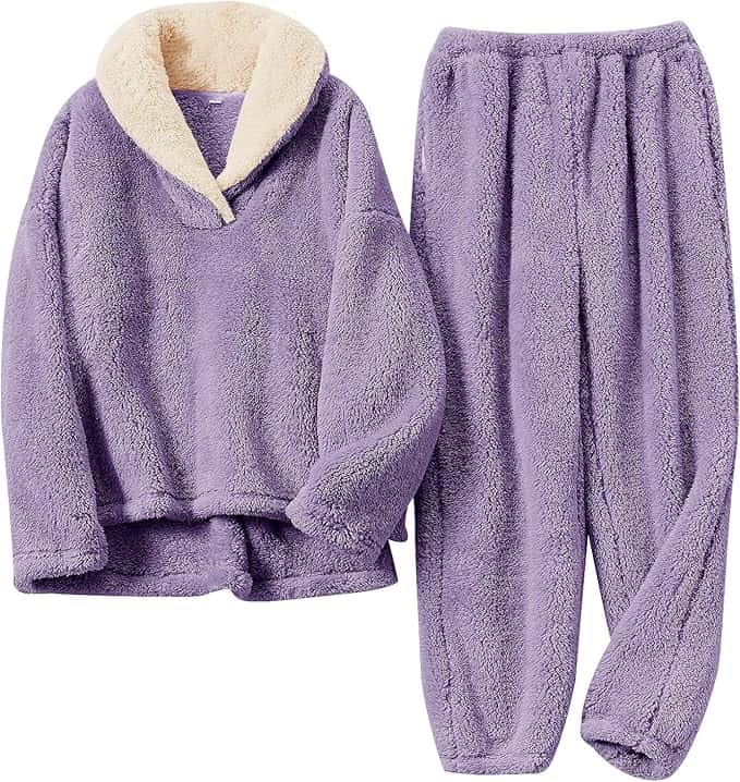 A two-piece loungewear set with a fuzzy lavender pullover featuring a cream collar and matching lavender pants, both made of soft fleece material.