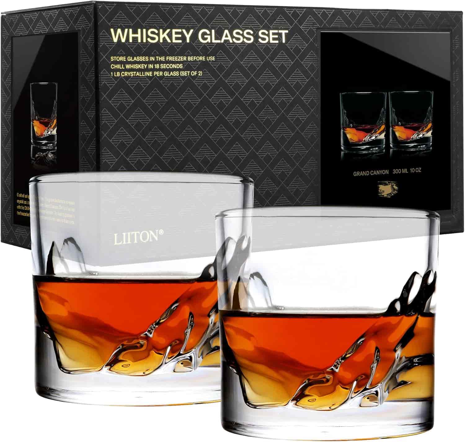 Two whiskey glasses with amber liquid, placed in front of a black box labeled "Whiskey Glass Set" with product images and branding visible.