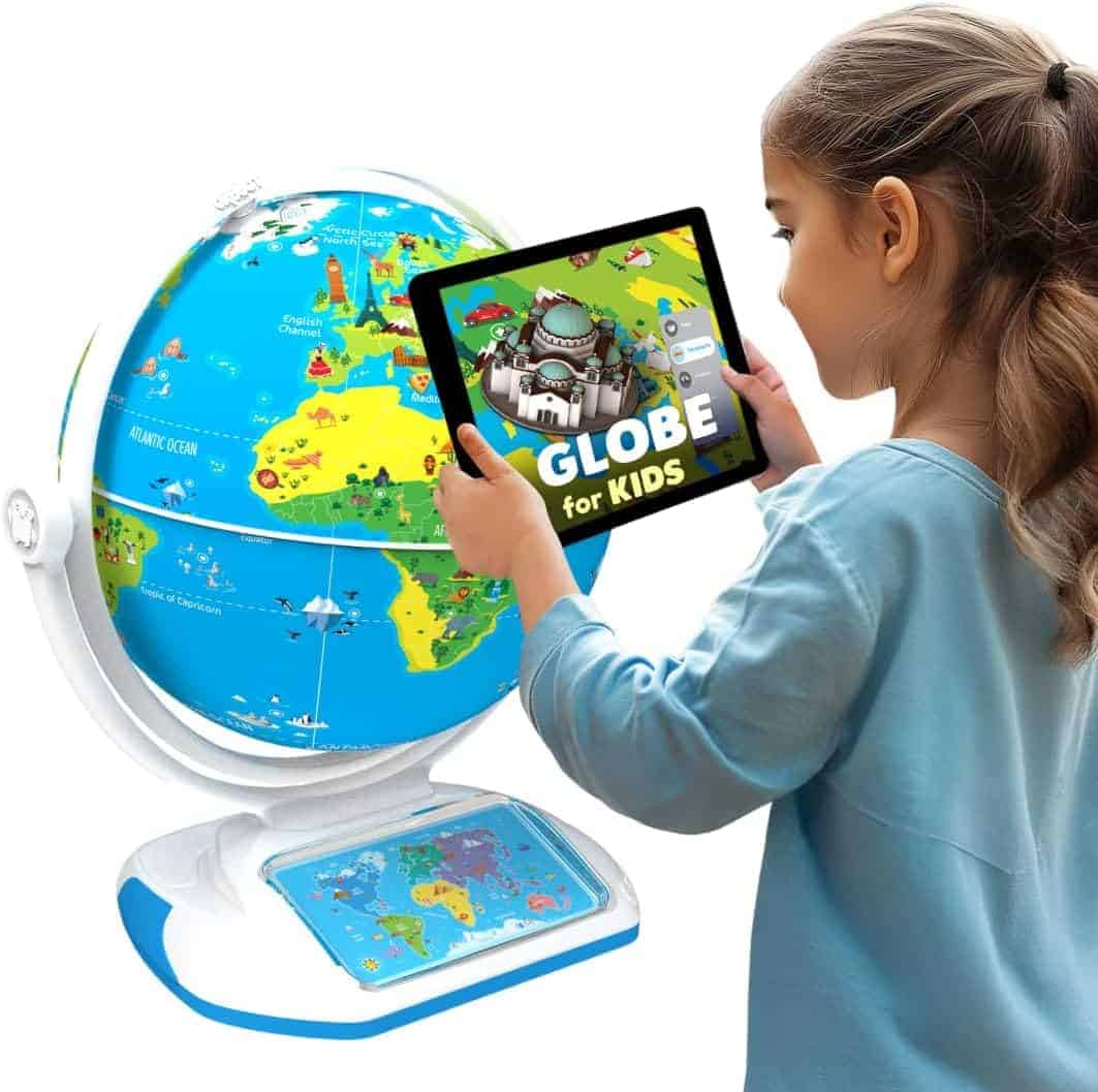 A child uses a tablet with an educational app while standing next to a colorful kids’ globe and a world map base.