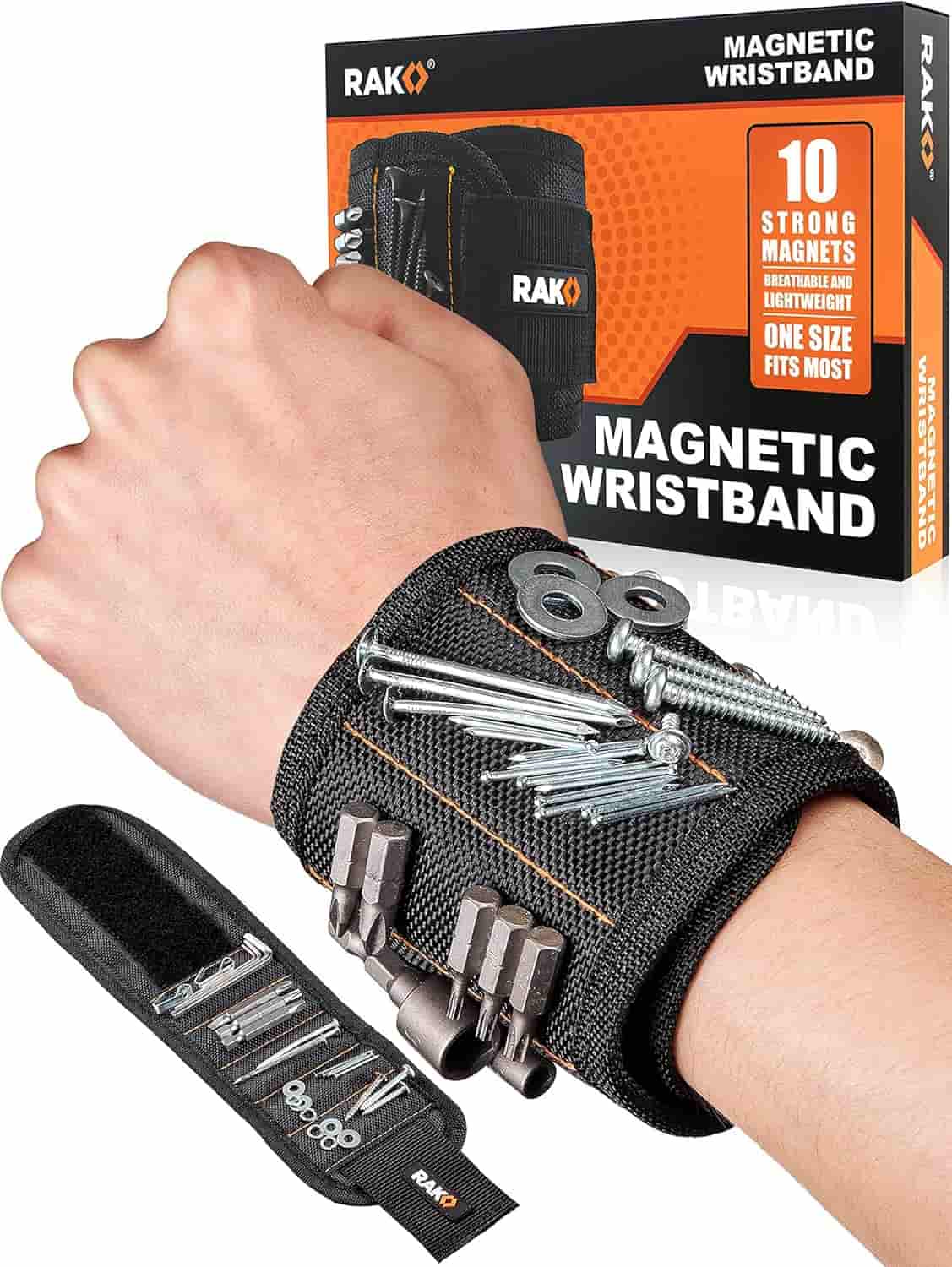 A hand wearing a black magnetic wristband holding metal screws, nuts, and bolts, with product packaging and an accessory pouch shown in the background.