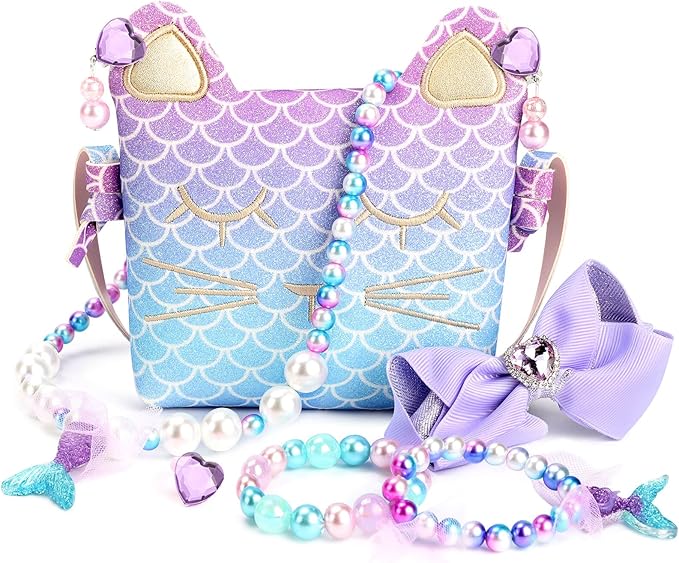 A small, glittery handbag with cat ears and mermaid-scale pattern, surrounded by colorful beaded jewelry and a purple bow accessory.