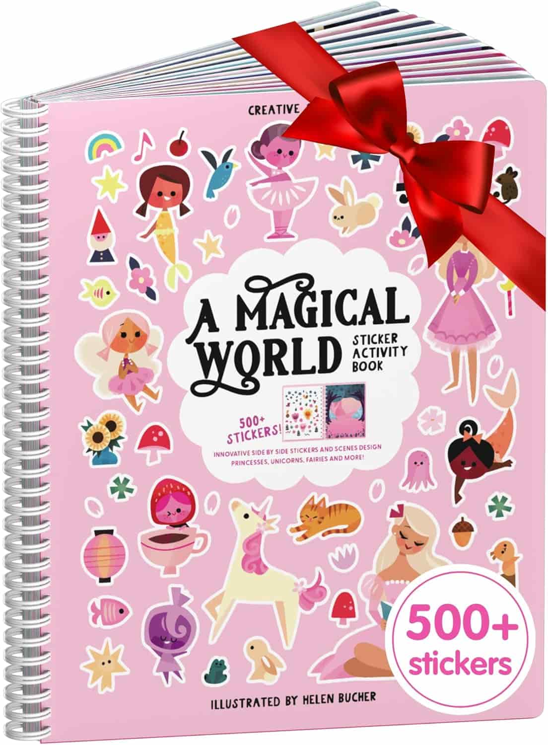 A spiral-bound sticker activity book titled "A Magical World" with a red bow and over 500 stickers featuring fairies, unicorns, and other whimsical designs on a pink cover.
