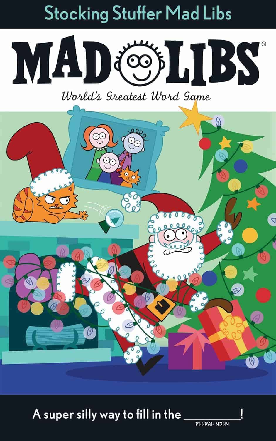 Illustrated cover of "Stocking Stuffer Mad Libs" showing Santa and a cat in pajamas sneaking near a decorated Christmas tree and fireplace, with wrapped gifts and a family photo in the background.
