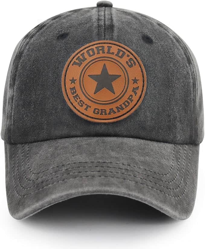 A dark gray baseball cap with a brown patch on the front that reads “WORLD'S BEST GRANDPA” with a star in the center.