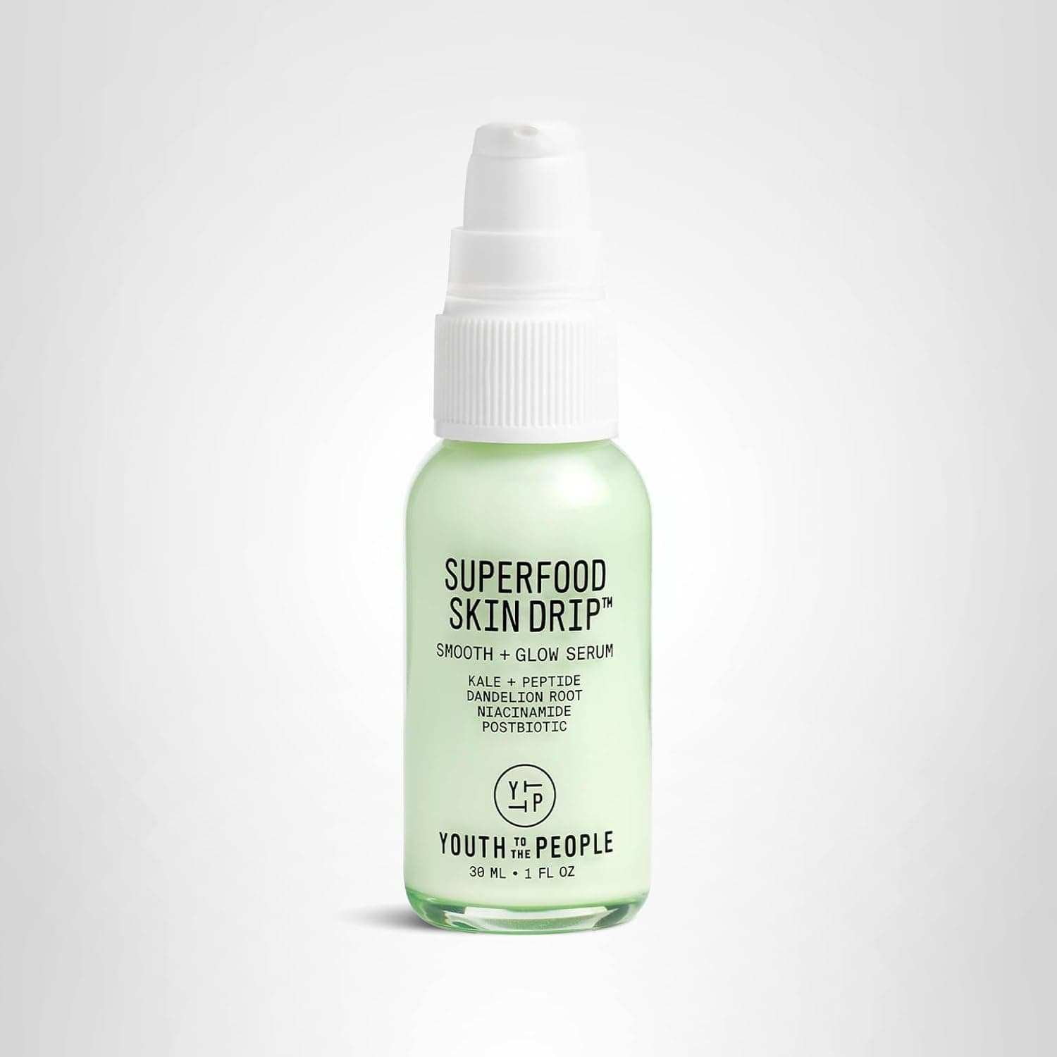 A small green bottle labeled "Superfood Skin Drip Smooth + Glow Serum" by Youth To The People, featuring a white pump top and a minimalist design.