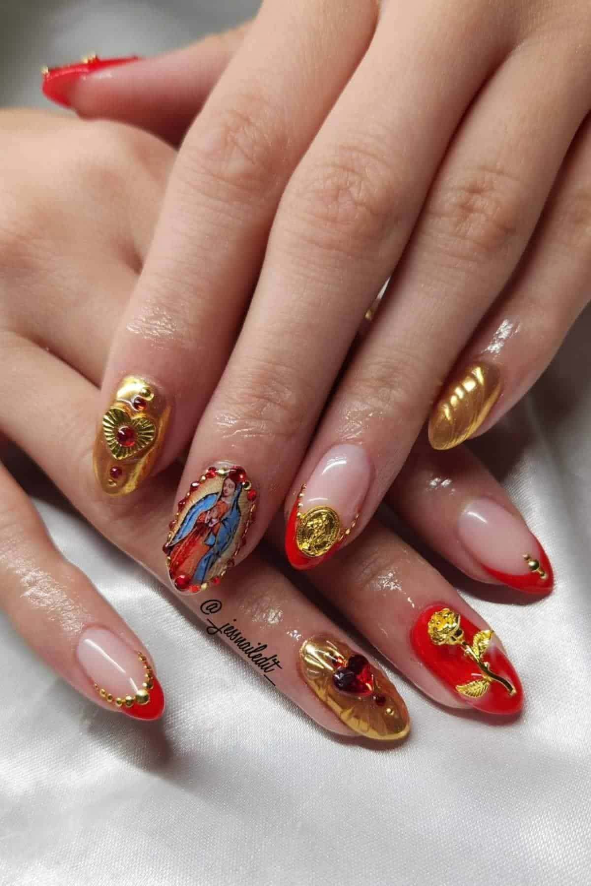 Close-up of hands with almond-shaped nails featuring red and gold designs, religious icon art, gold accents, and embellishments.