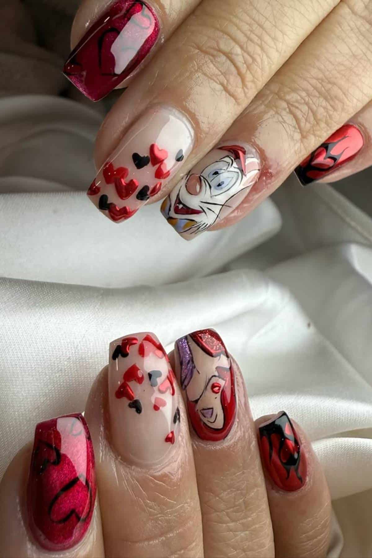 Close-up of hands with manicured nails featuring red and black abstract designs and cartoon character art on two nails.