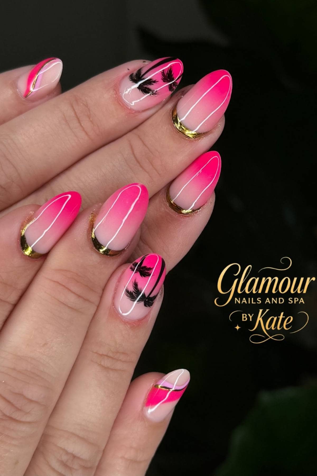 Hand with almond-shaped nails featuring pink ombre, gold tips, black palm tree designs, and white line accents. "Glamour Nails and Spa by Kate" logo in lower right corner.
