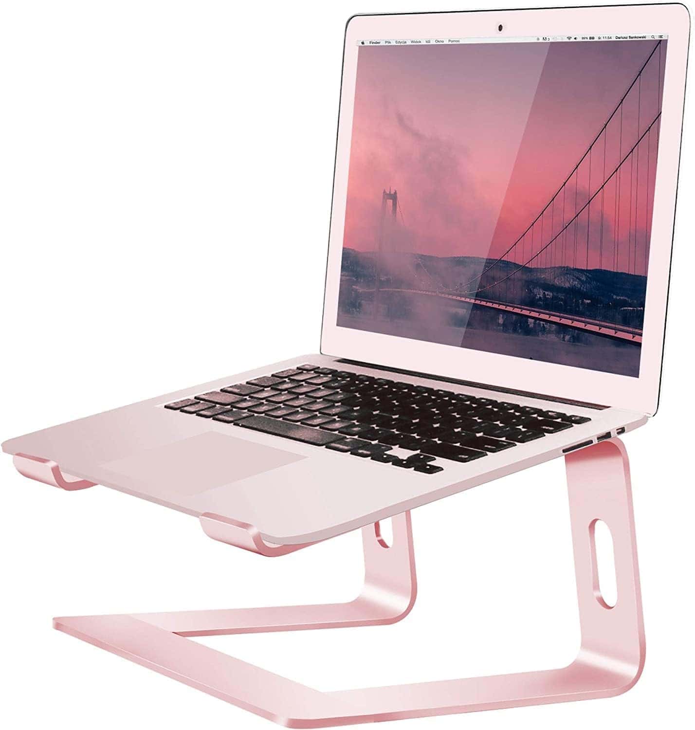 A silver laptop sits on a pink metal stand, displaying a bridge wallpaper on its screen.