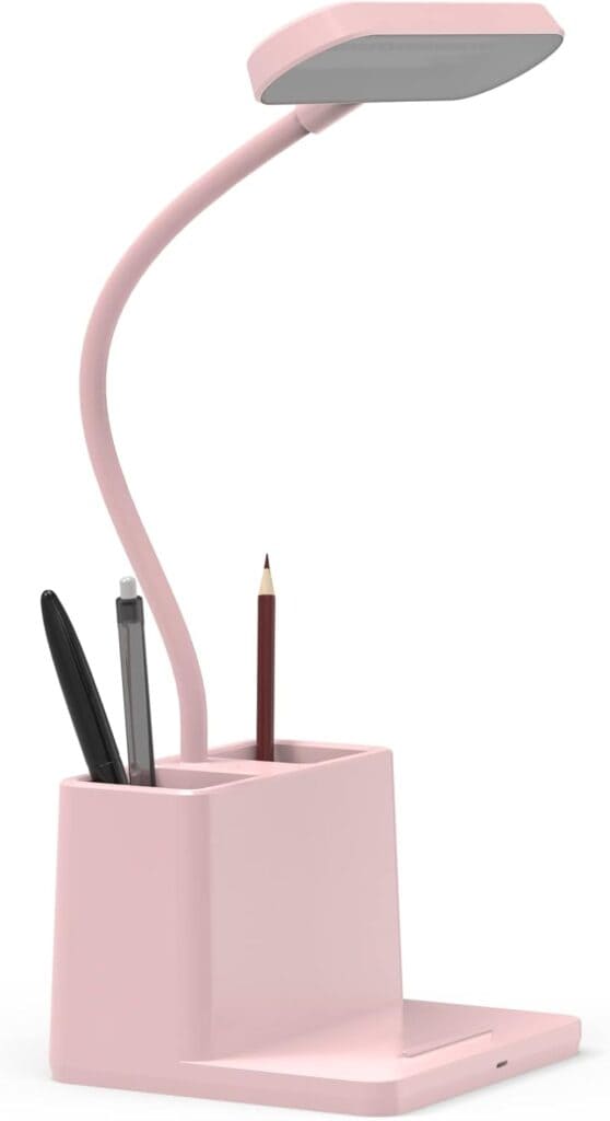 A pink desk organizer with a built-in LED lamp, holding a pen, pencil, and marker, with a slot for holding a phone at the base.