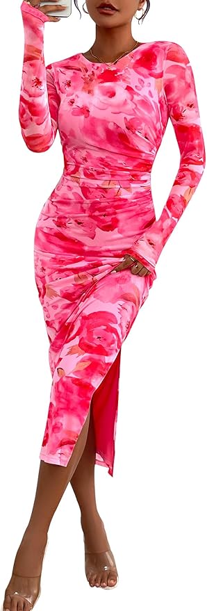 A person wears a long-sleeve, fitted pink floral dress with a side slit and clear high-heeled shoes, posing while taking a mirror selfie.