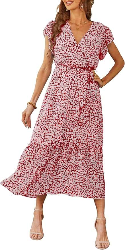 A woman wearing a red and white floral print midi dress with short sleeves, a V-neck, and beige ankle-strap heels.