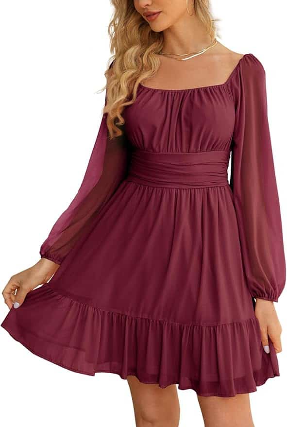 Woman wearing a long-sleeve, square-neck, burgundy dress with a fitted waist and ruffled hem, posing against a plain background.