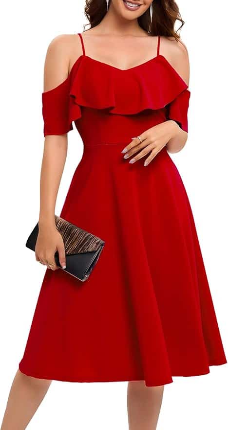 Woman wearing a knee-length, off-shoulder red dress with ruffle detail, holding a black clutch bag.