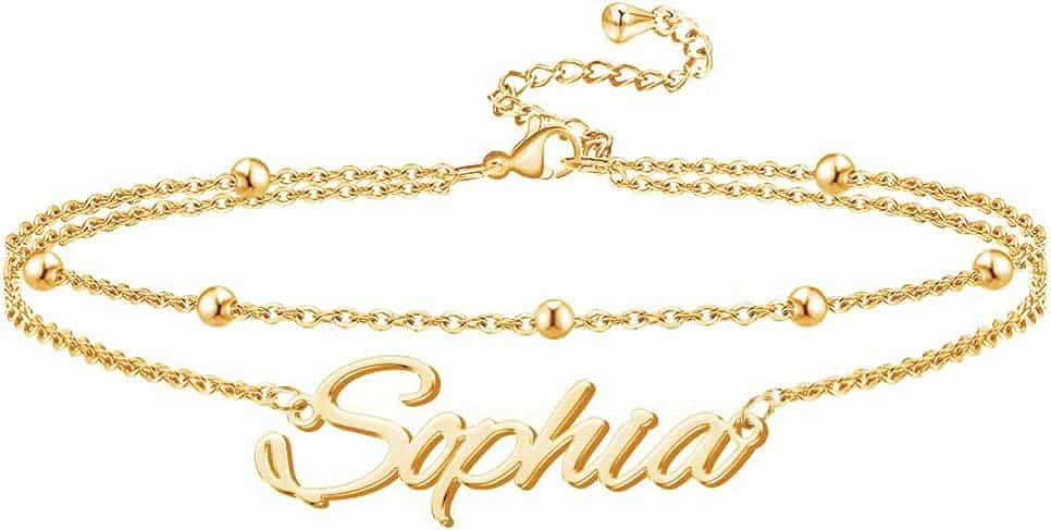 A gold chain bracelet with bead accents and a pendant featuring the name "Sophia" in cursive lettering.