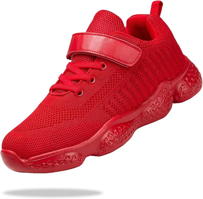 A bright red athletic shoe with a mesh upper, lace-up front, velcro strap, and textured rubber sole, isolated on a white background.