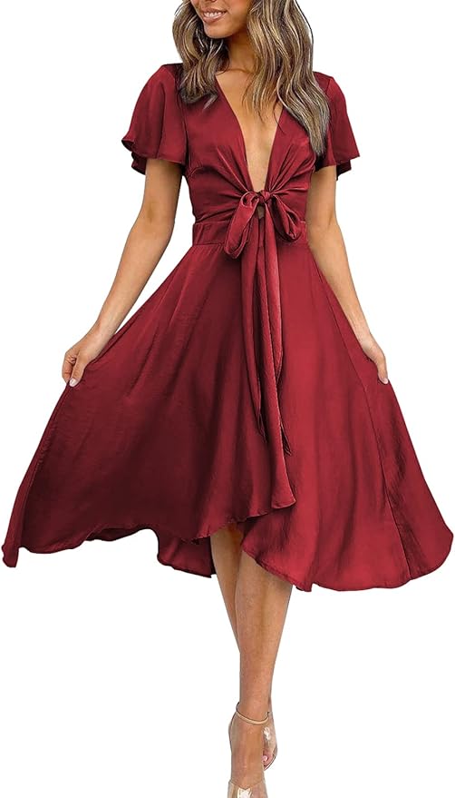 Woman wearing a deep red, short-sleeve, V-neck midi dress with a front tie and flared skirt, standing against a white background.