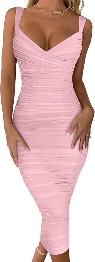 A woman wearing a form-fitting, sleeveless, light pink midi dress with ruched detailing and a deep V-neckline.