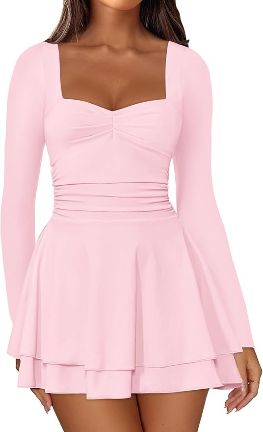 Woman wearing a light pink, long-sleeve, square-neck dress with a fitted bodice and flared, layered skirt.