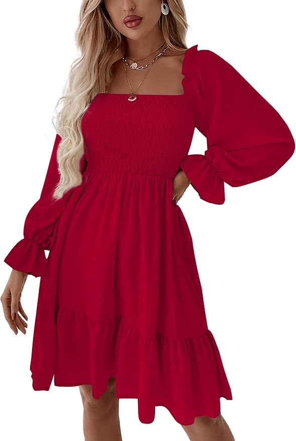 Woman wearing a bright red, long-sleeved, square-neck dress with a smocked bodice and ruffled hem, accessorized with layered necklaces.