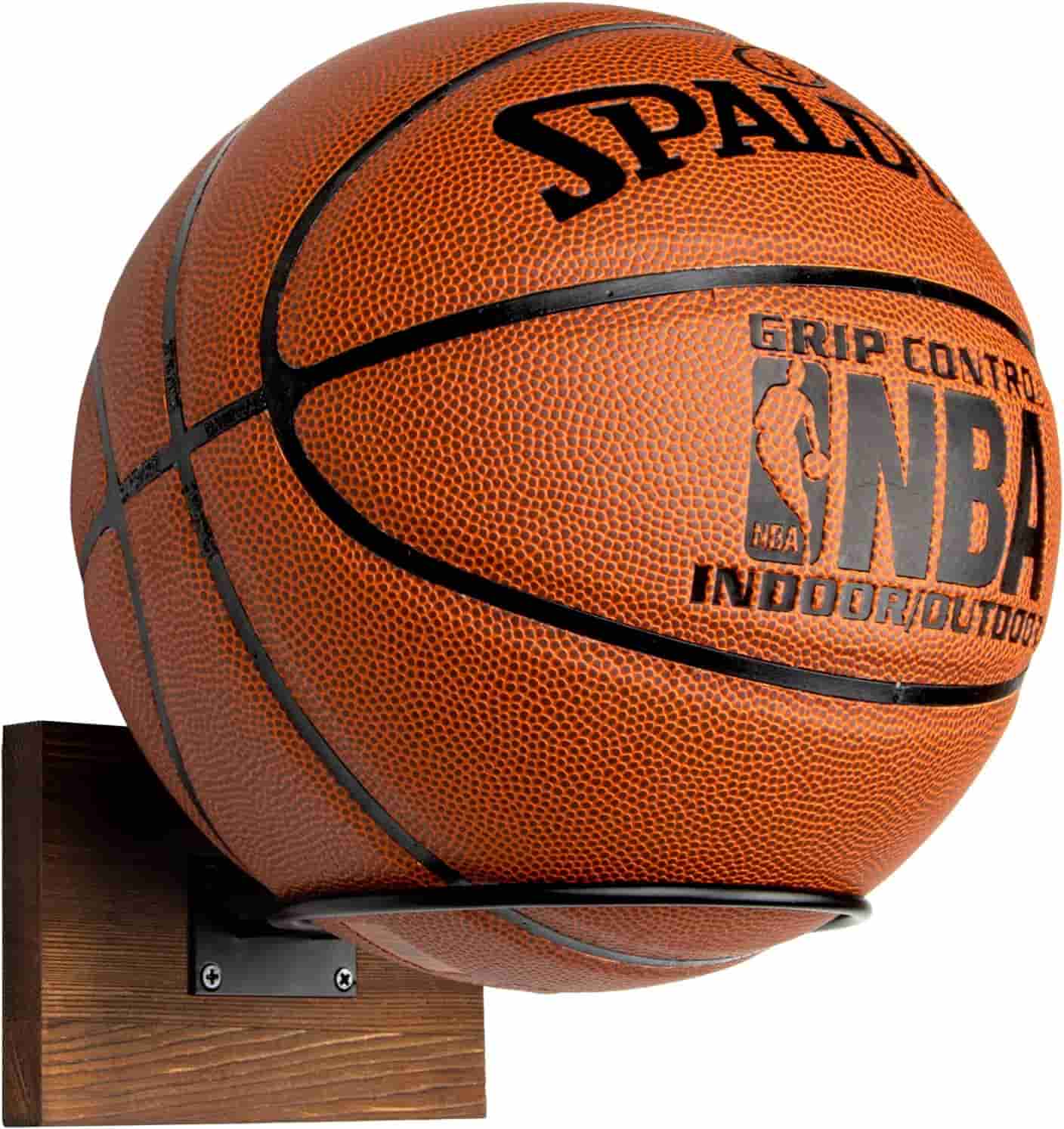 A Spalding NBA Grip Control basketball displayed on a wall-mounted wooden holder.