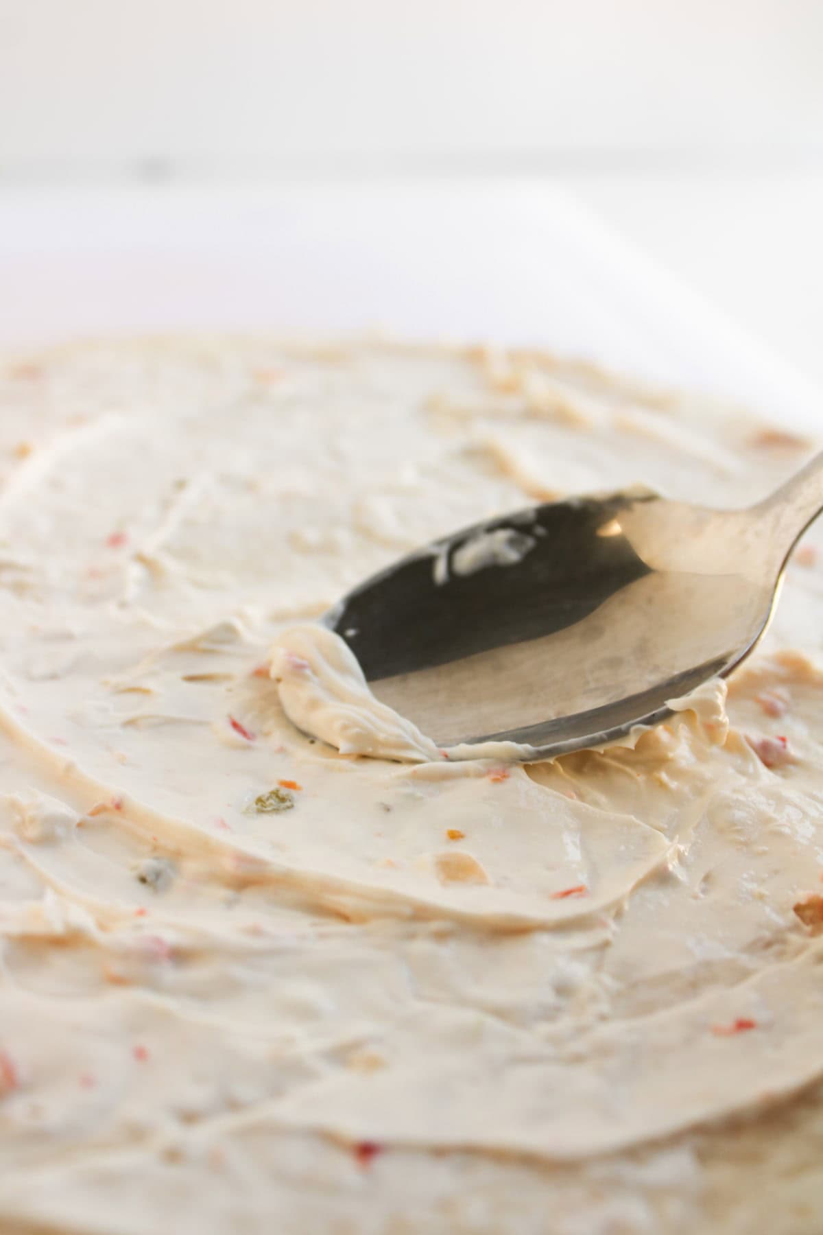 A spoon on a white surface.